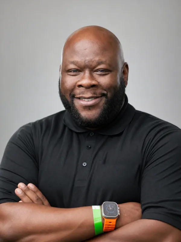 Quenton Robinson, founder of BLACKNUNITED, smiling with arms crossed